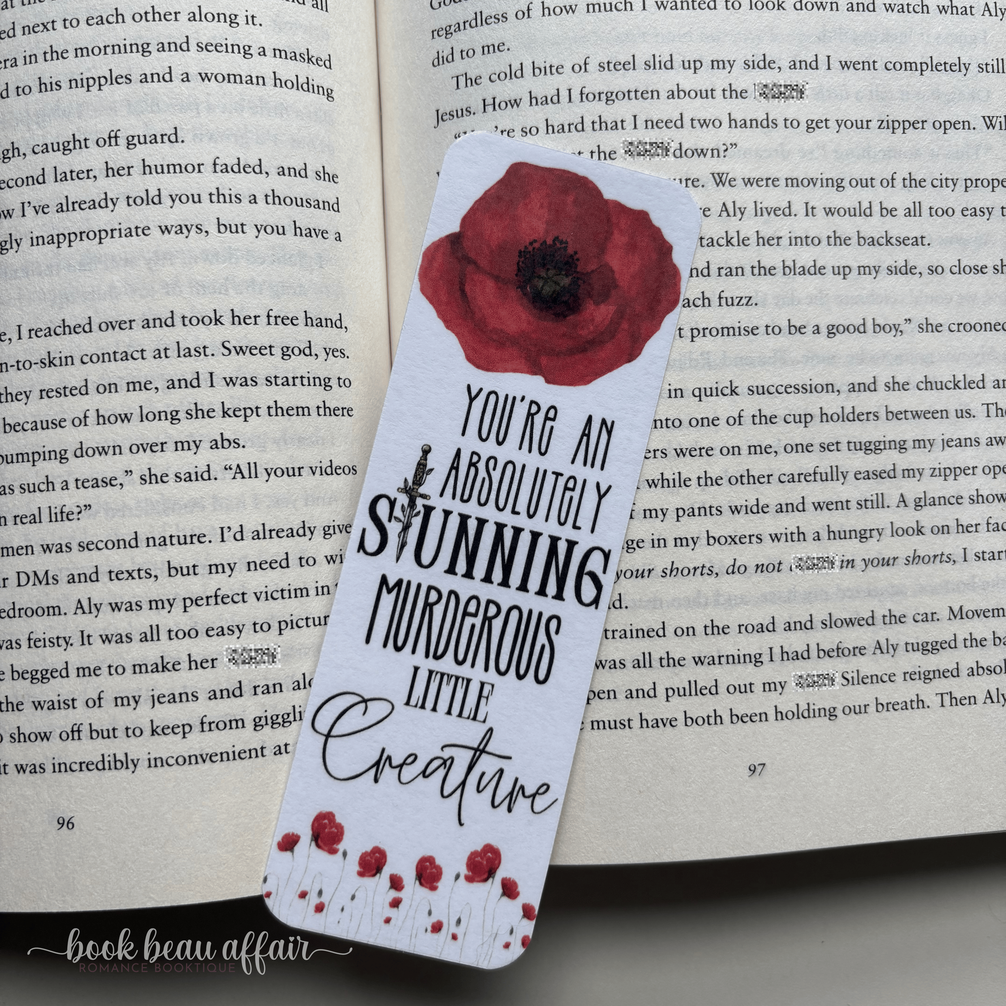 bookmark with the text you're an absolutely stunning murderous little creature. it also has an image of a red poppy flower