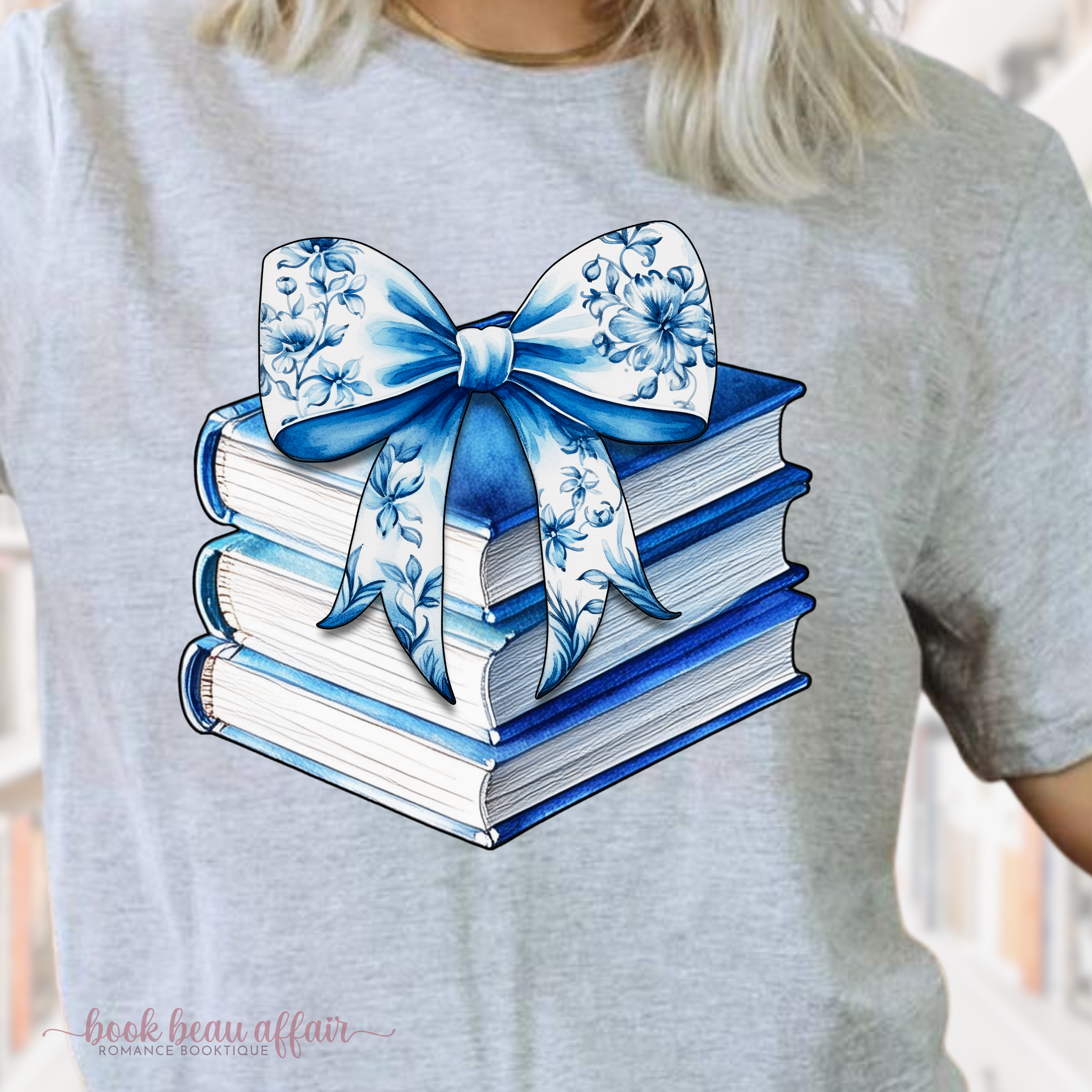 Close Up of watercolor stack of books and chinoiserie floral bow on top. coquette-style bow. soft bookish tee. Sport Gray
