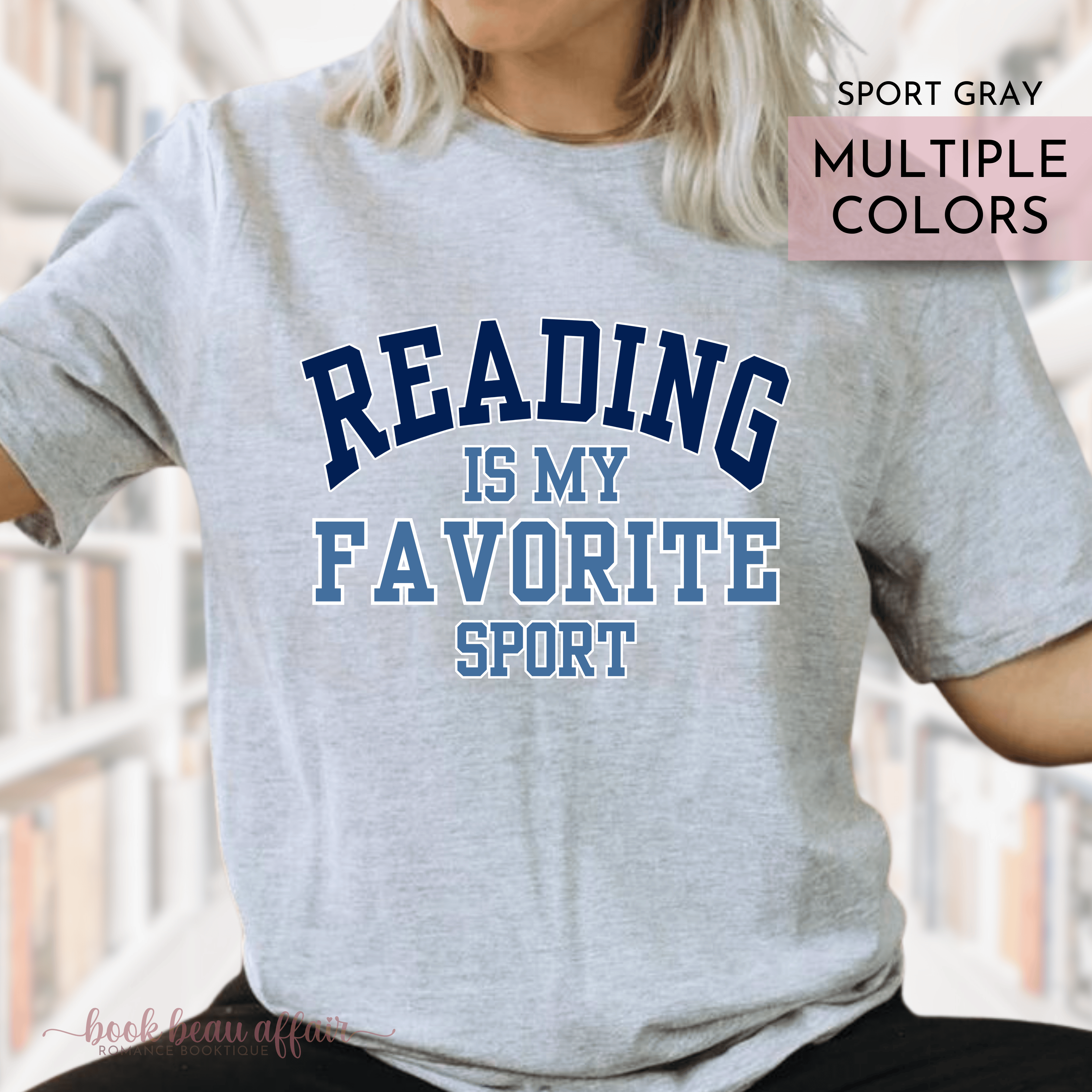 Gray t-shirt with 'Reading is my favorite sport' text worn by a person, with blurred background.