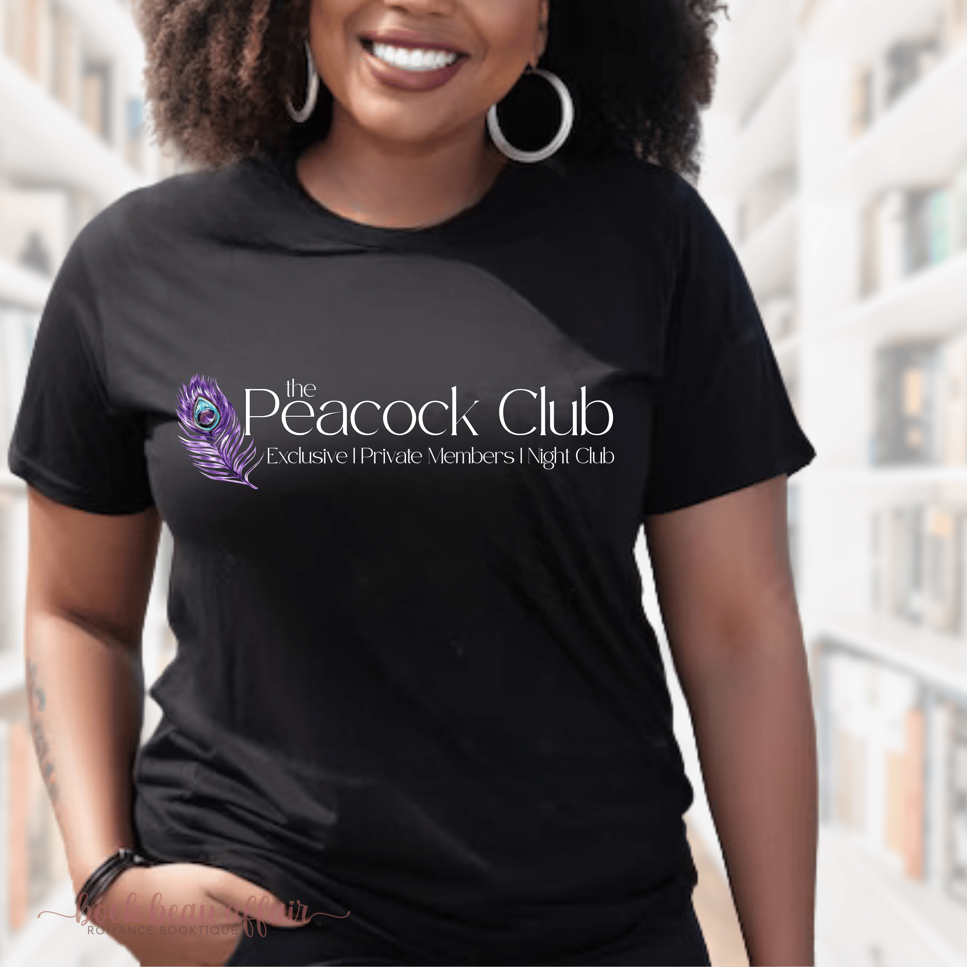 Person wearing a black t-shirt with 'The Peacock Club' logo Ryan Rule Series