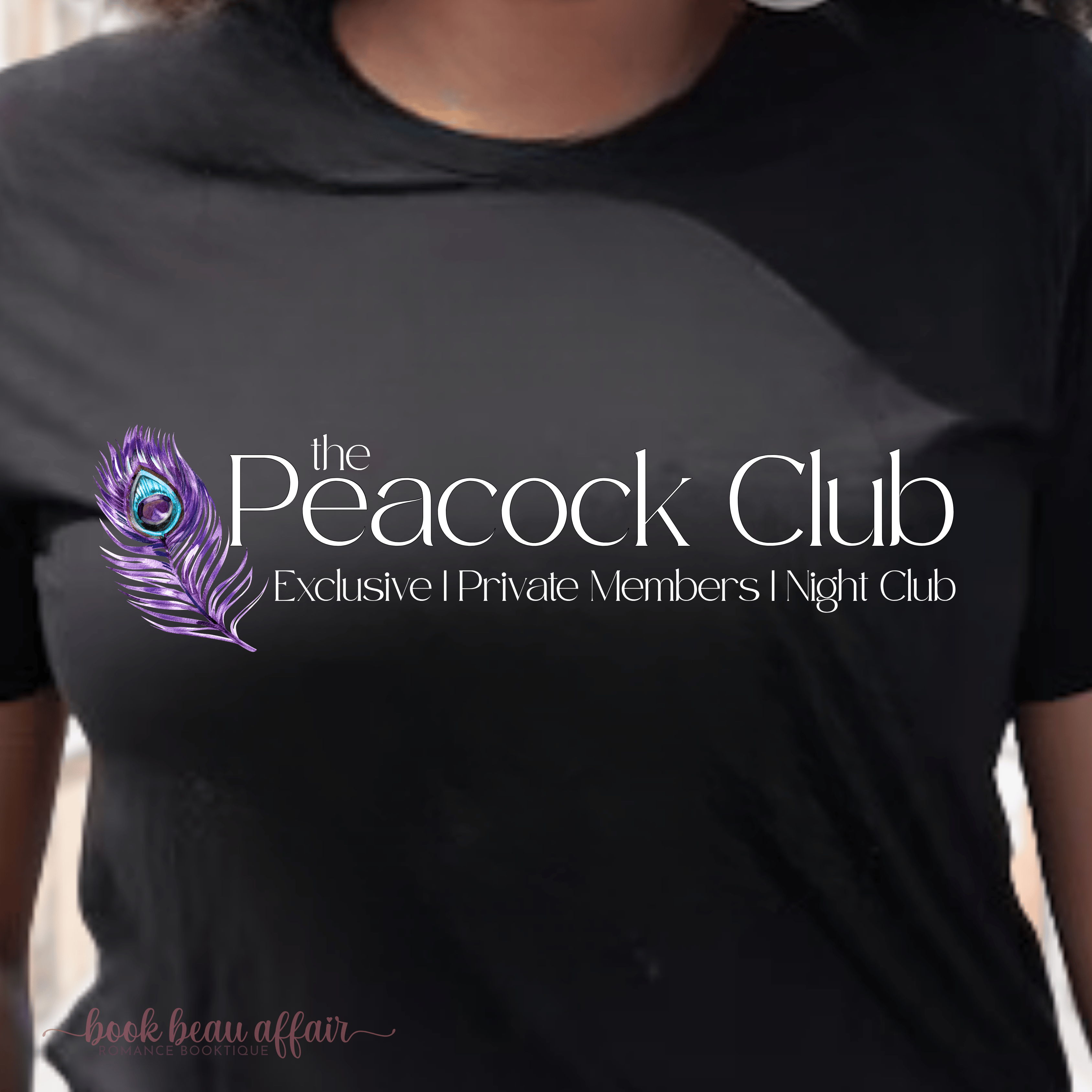 Black t-shirt with 'The Peacock Club' logo and text on a person wearing it. a reference to the Ryan Rule Series by Sadie Kincaid