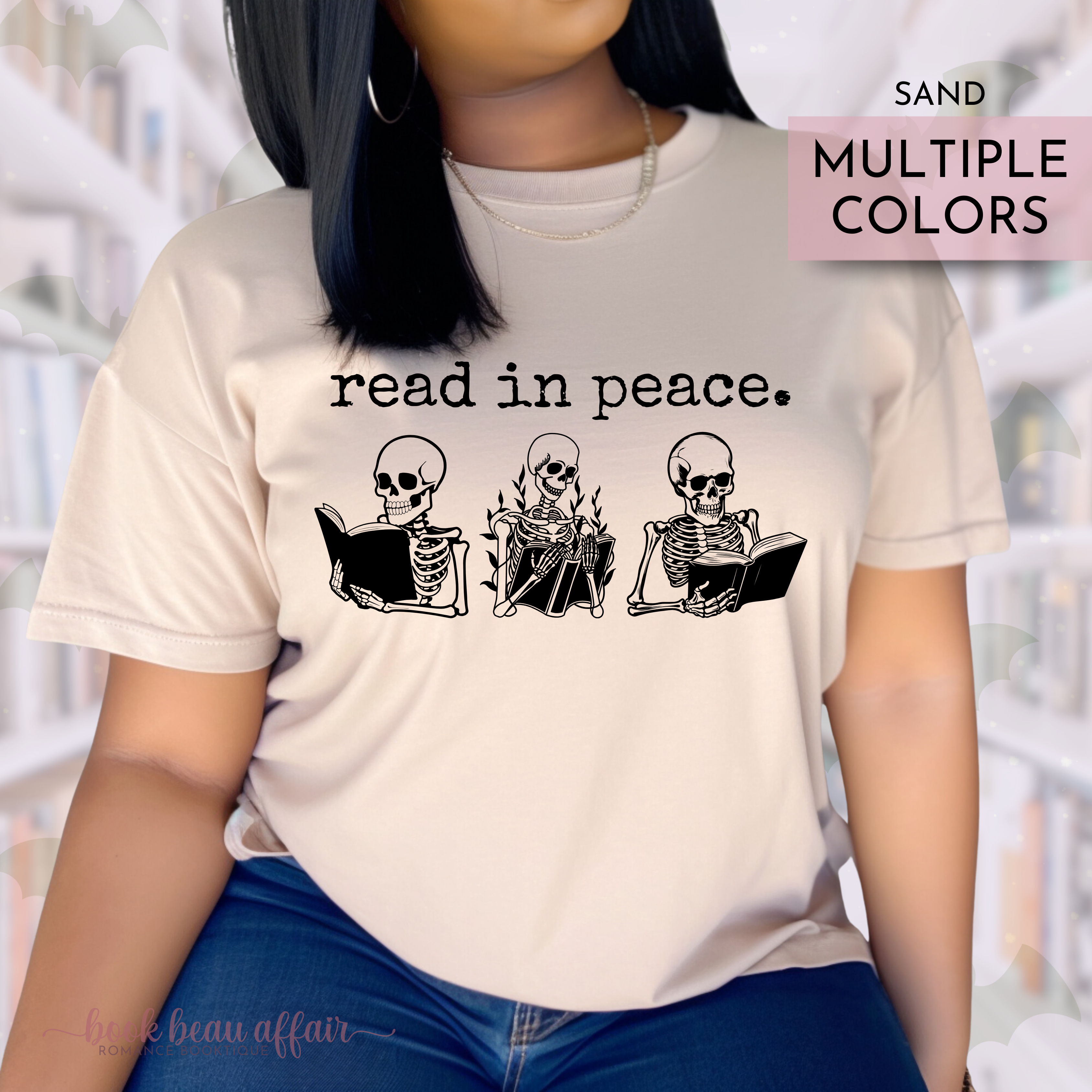 Person wearing a t-shirt with skeleton illustrations and 'read in peace' text, set against a blurred library background.