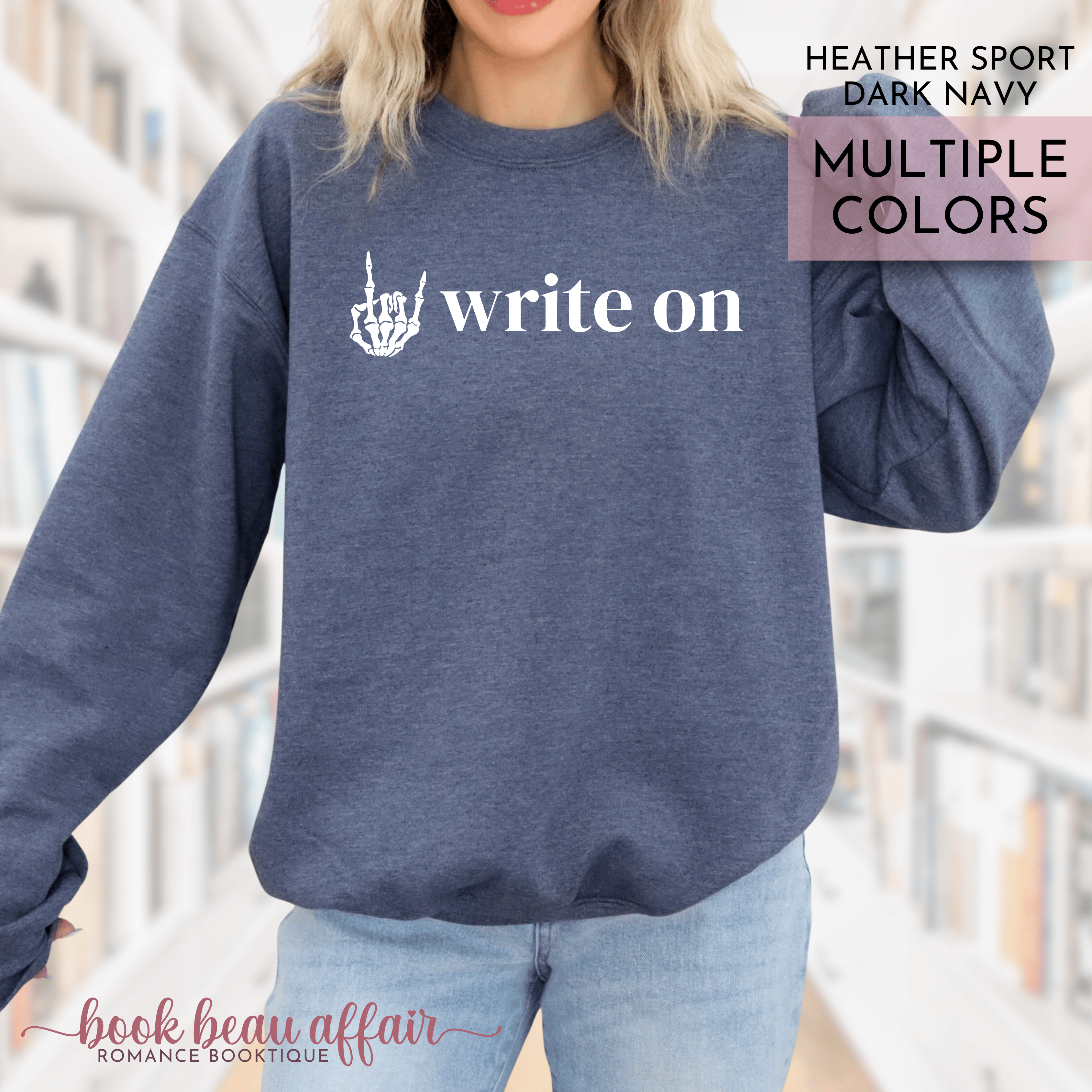 Navy sweatshirt with 'write on' text and rock on hand gesture graphic worn by a person