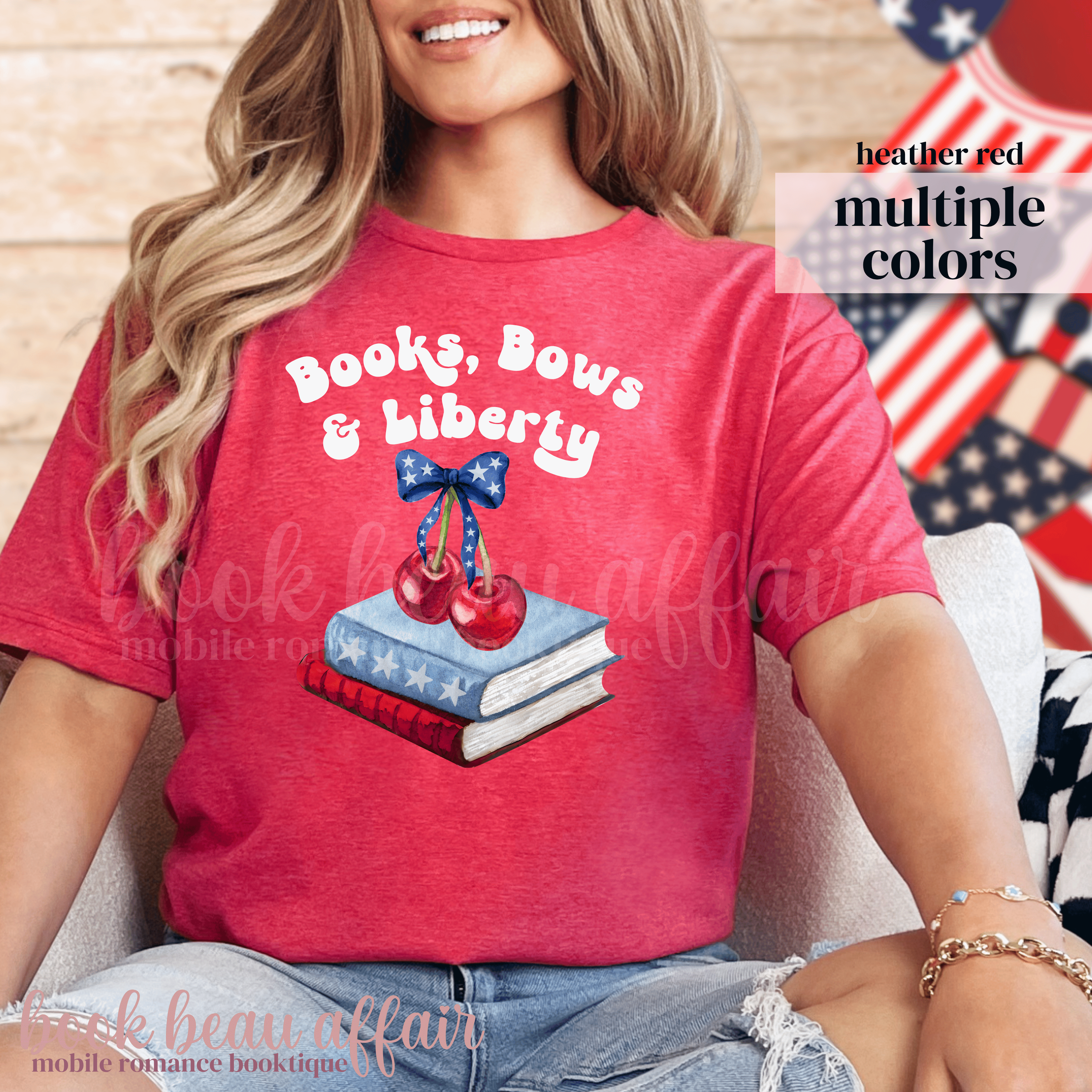 Person wearing a red t-shirt with 'Books, Bows & Liberty' design, sitting in front of an American flag.