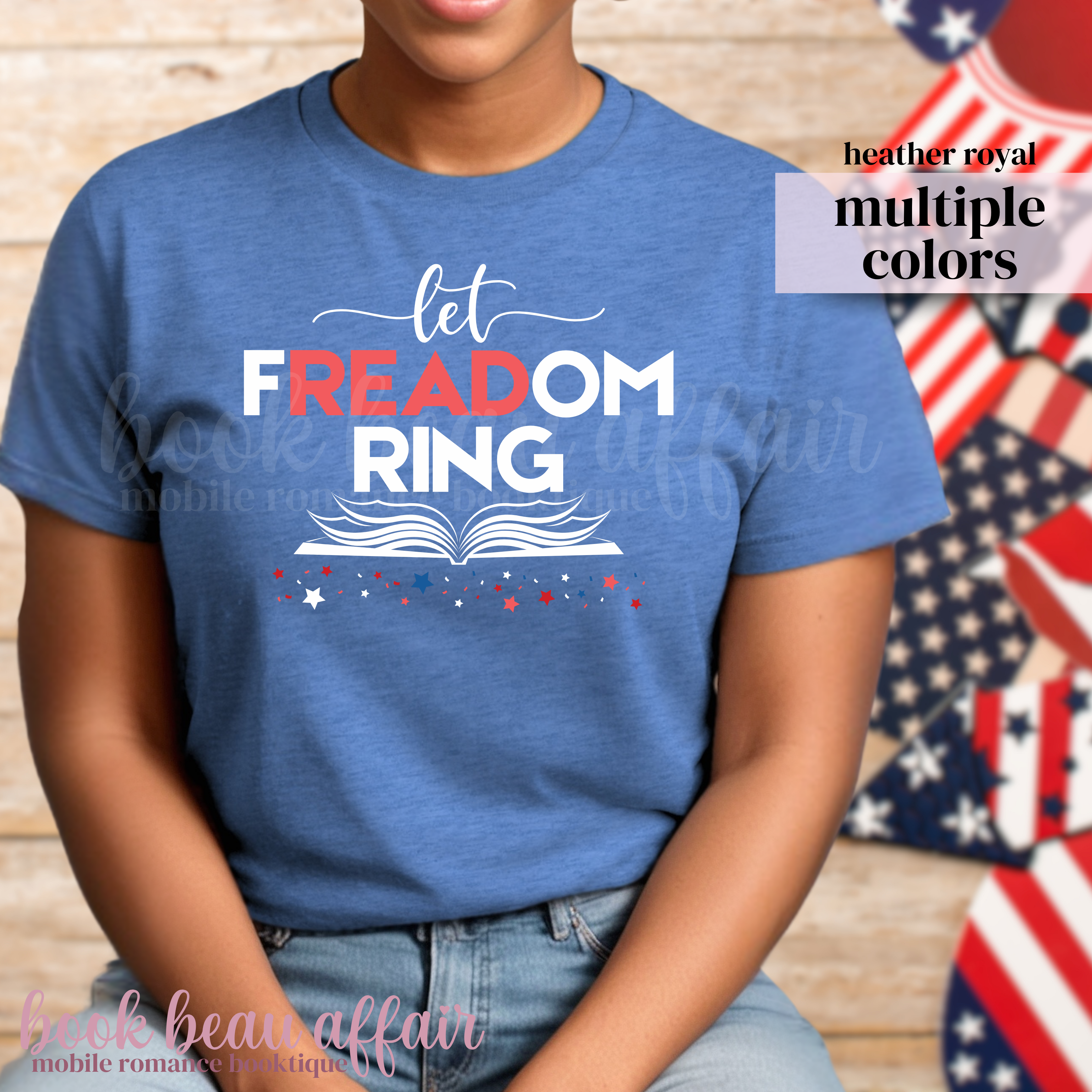 Person wearing a blue t-shirt with 'let FREEDOM RING' text in front of American flags.