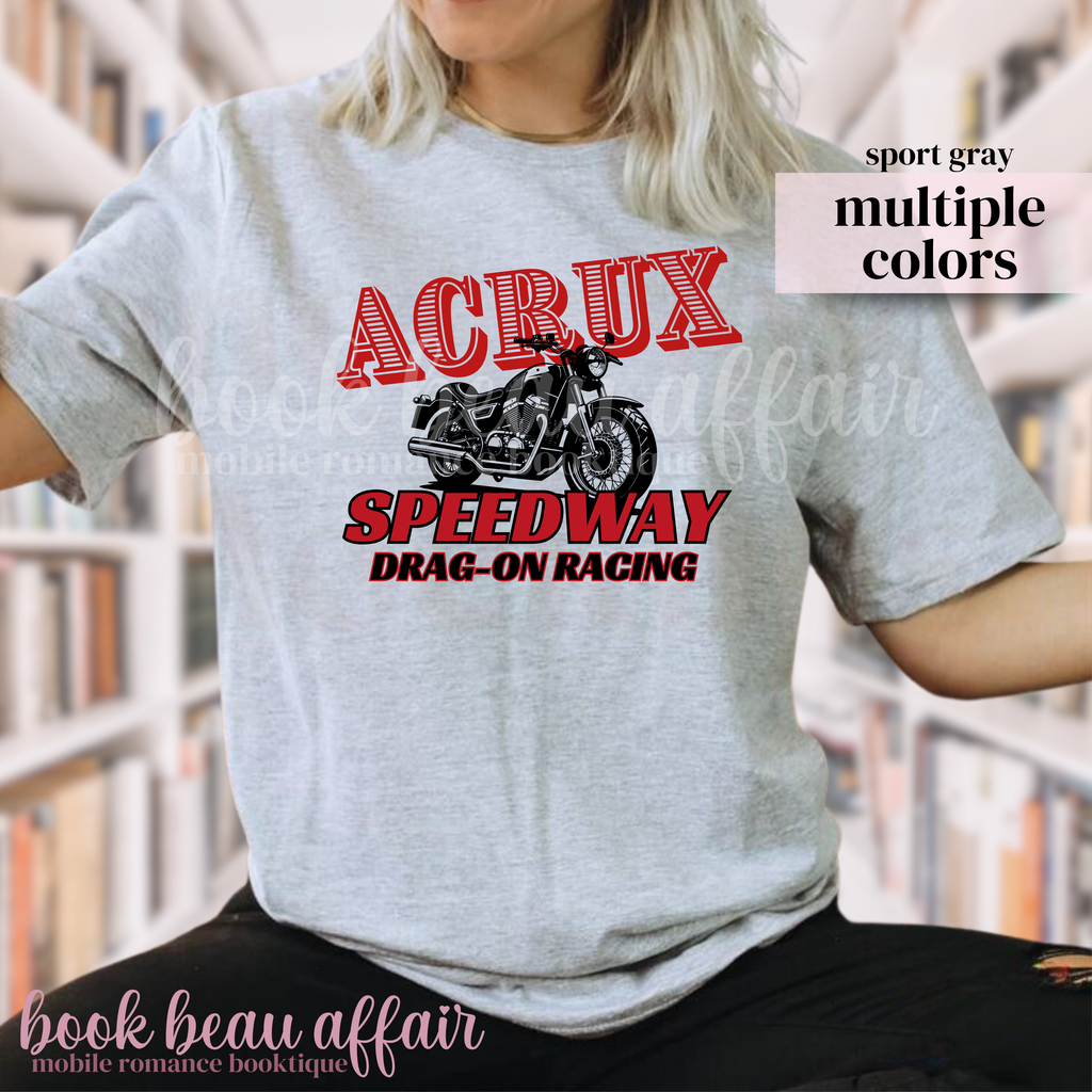 Person wearing a gray t-shirt with a motorcycle graphic and text, that says Acrux Speedway. Drag-on racing
