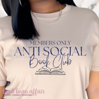 Person wearing a t-shirt with 'Members Only Anti Social Book Club' text and an open book graphic.