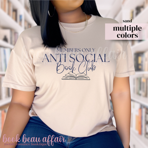 Person wearing a 'Members Only Anti Social Book Club' t-shirt in a library setting