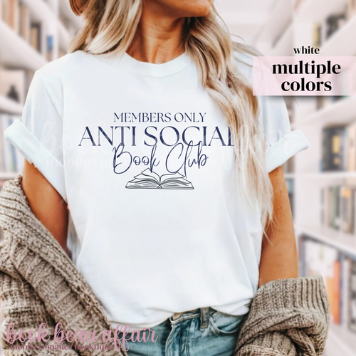 Person wearing a white t-shirt with 'Members Only Anti Social Book Club' text in a library setting.