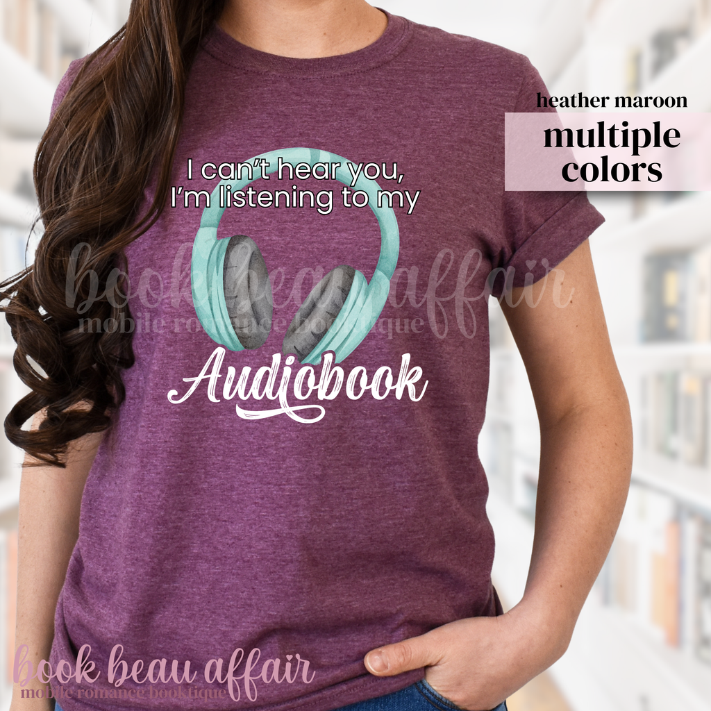 maroon t-shirt with teal headphones and 'I'm listening to my audiobook' text, worn by a person.
