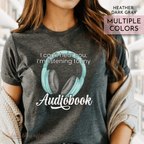 Person wearing a t-shirt with an audiobook design and text that says I can't hear you I'm listening to my audiobook