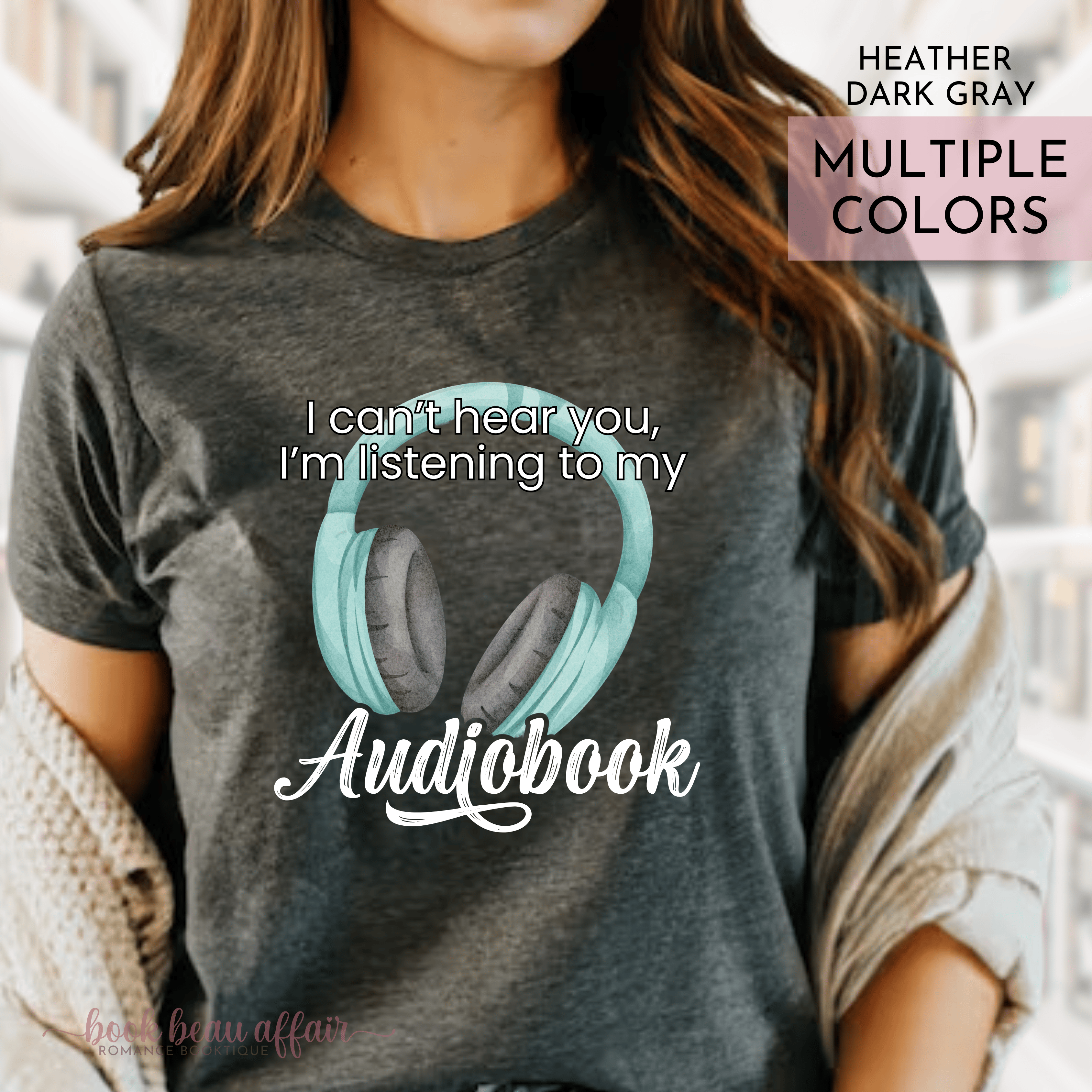 Person wearing a t-shirt with an audiobook design and text that says I can't hear you I'm listening to my audiobook