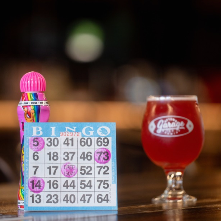 A bingo card and a glass with the Uptown Garage Brewing Ankeny logo