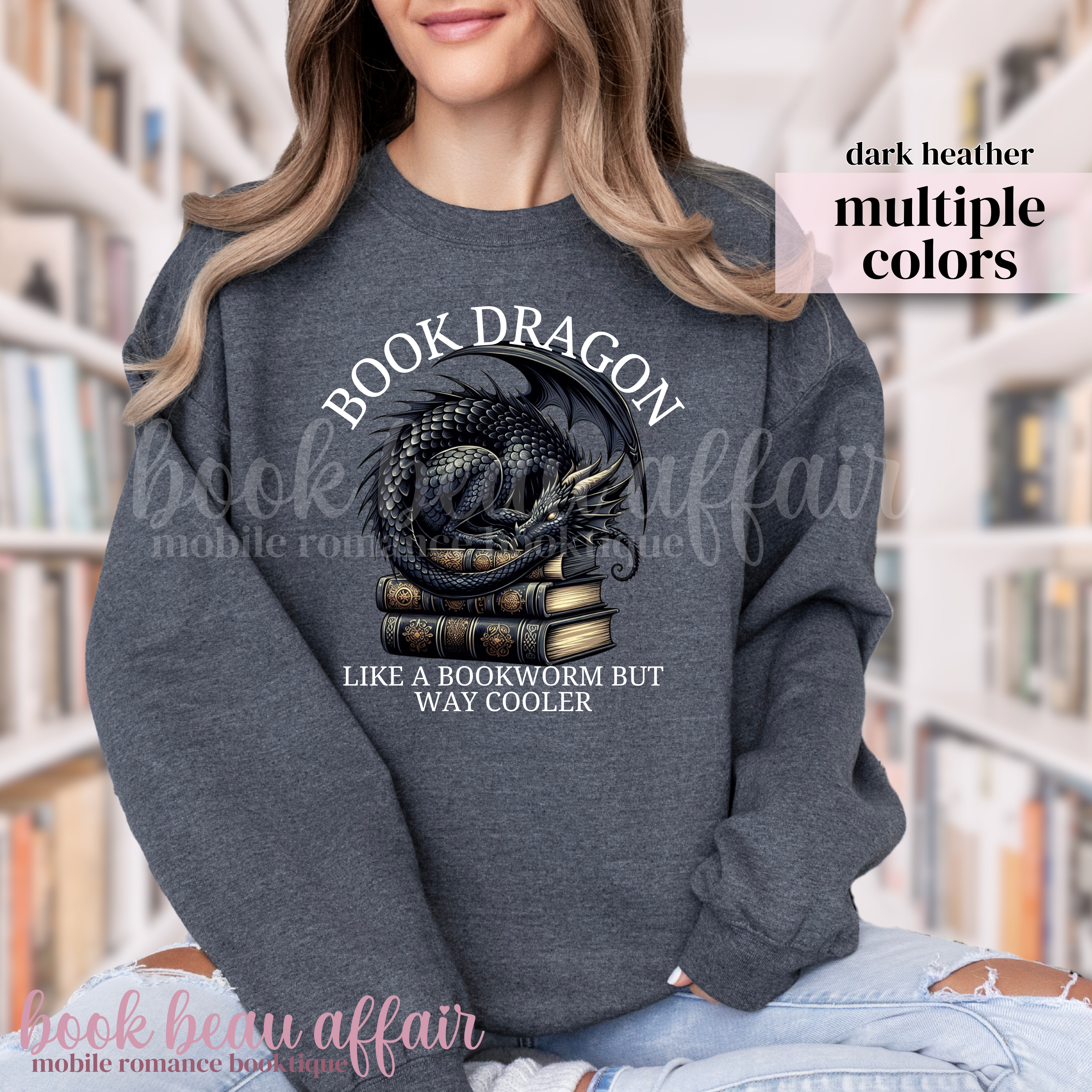 dark heather sweatshirt with a dragon laying on a stack of books and text that says book dragon, like a bookworm but way cooler