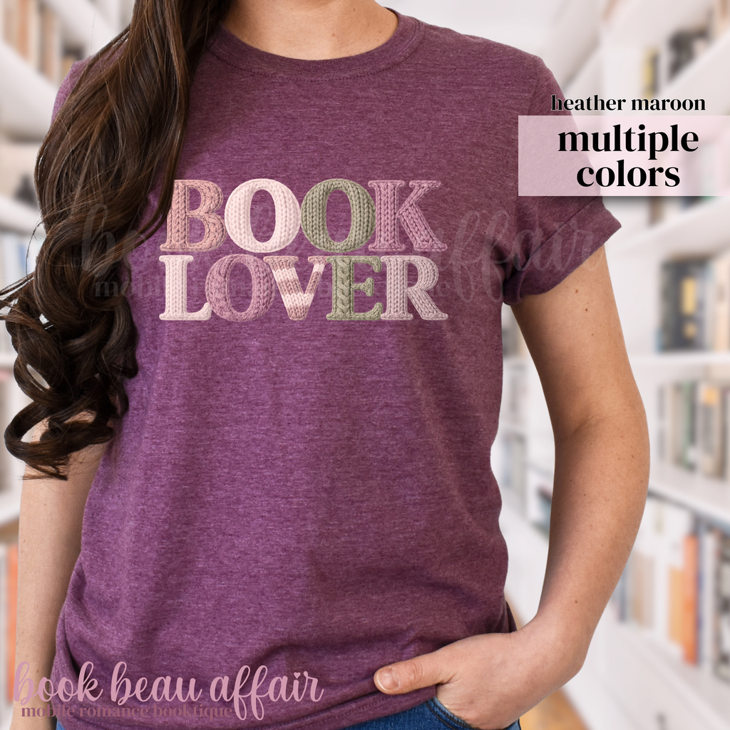 Maroon t-shirt with 'BOOK LOVER' text in a faux knitted font