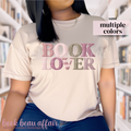Beige t-shirt with 'BOOK LOVER' text in a faux knitted font