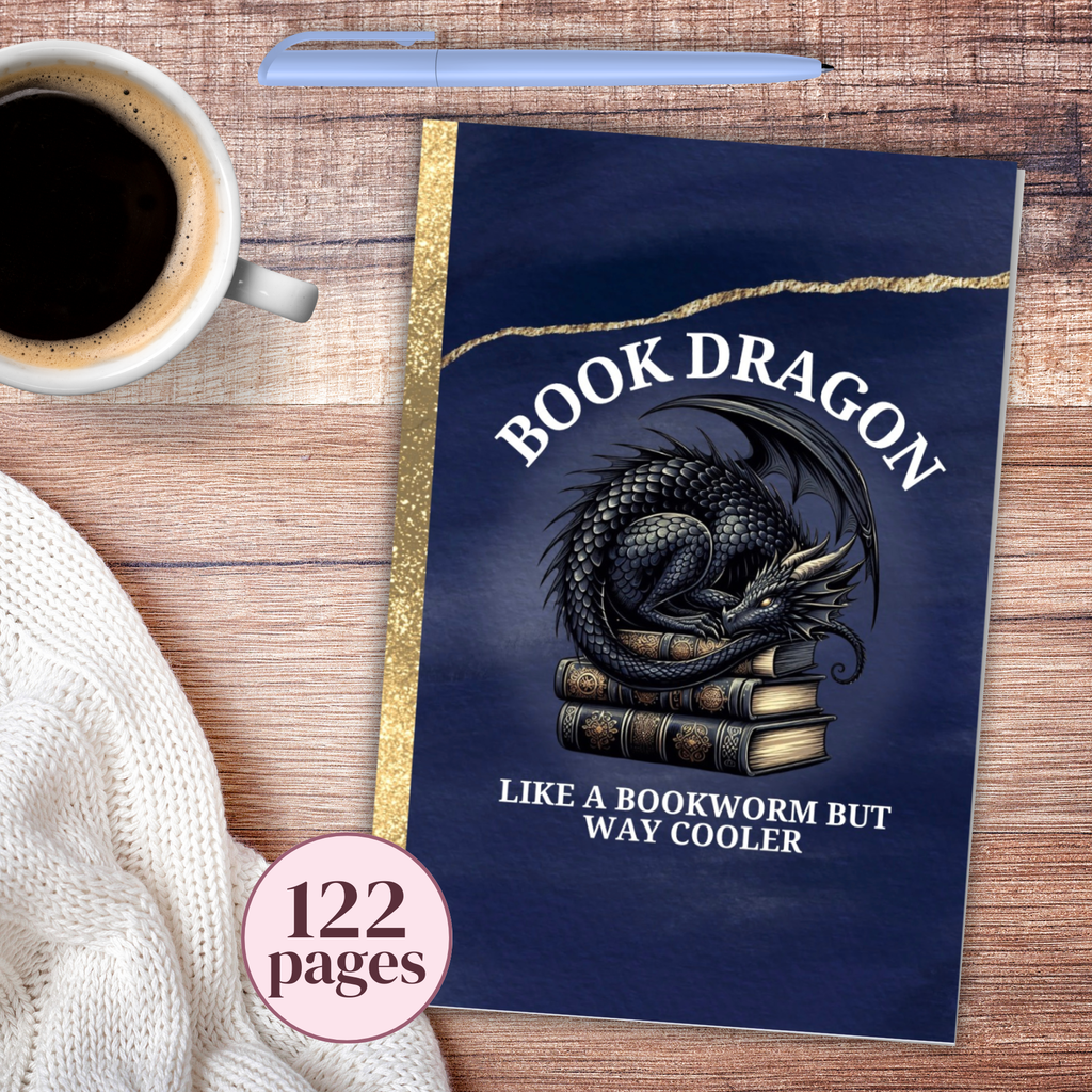Notebook with dragon design titled 'Book Dragon' on a wooden surface with coffee and sweater.