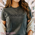 Person wearing a gray t-shirt with 'bookish' text, standing in a bookstore.