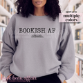Person wearing a gray sweatshirt with 'BOOKISH AF' text in a library setting