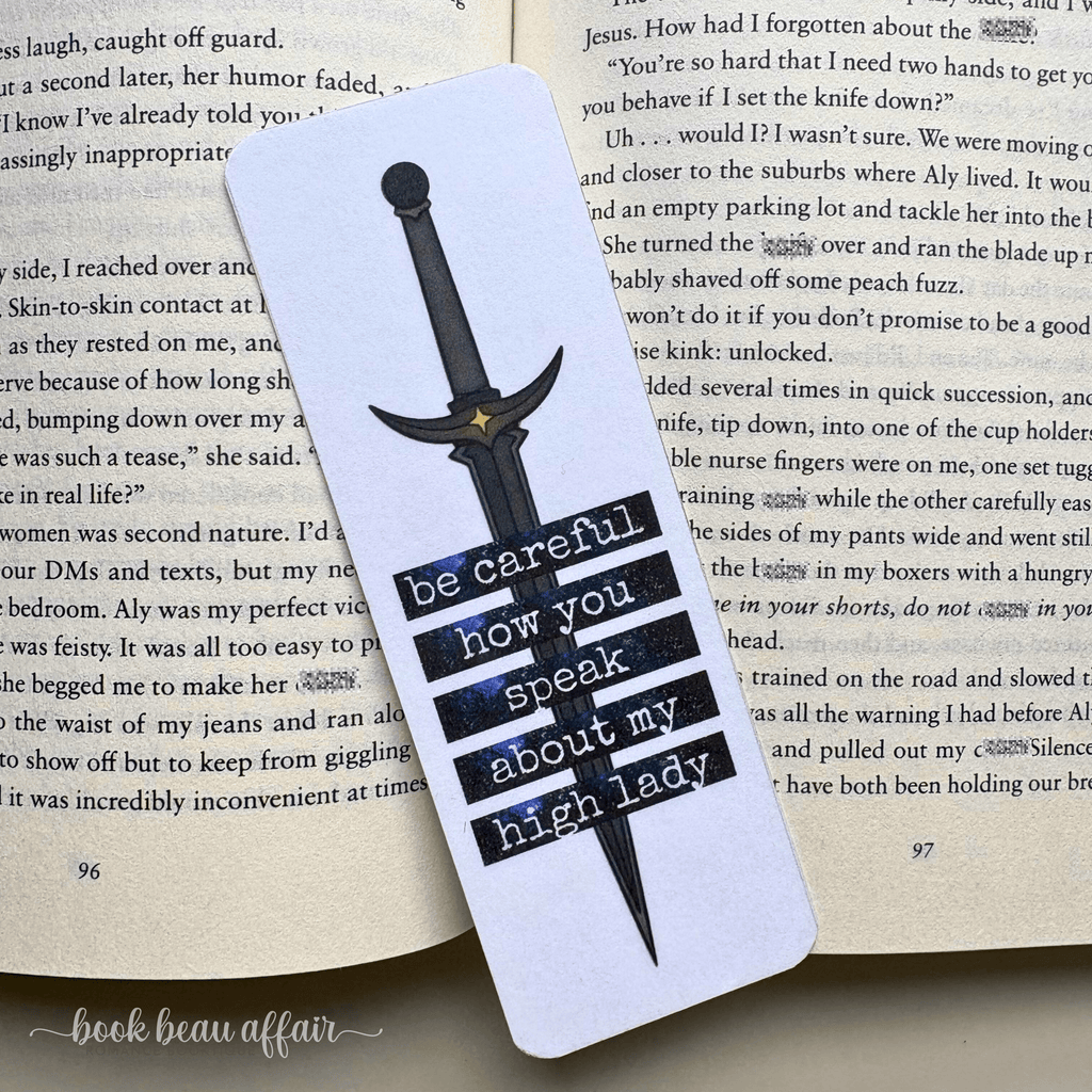 Bookmark with sword design and text on an open book. text says be careful how you speak about my high lady