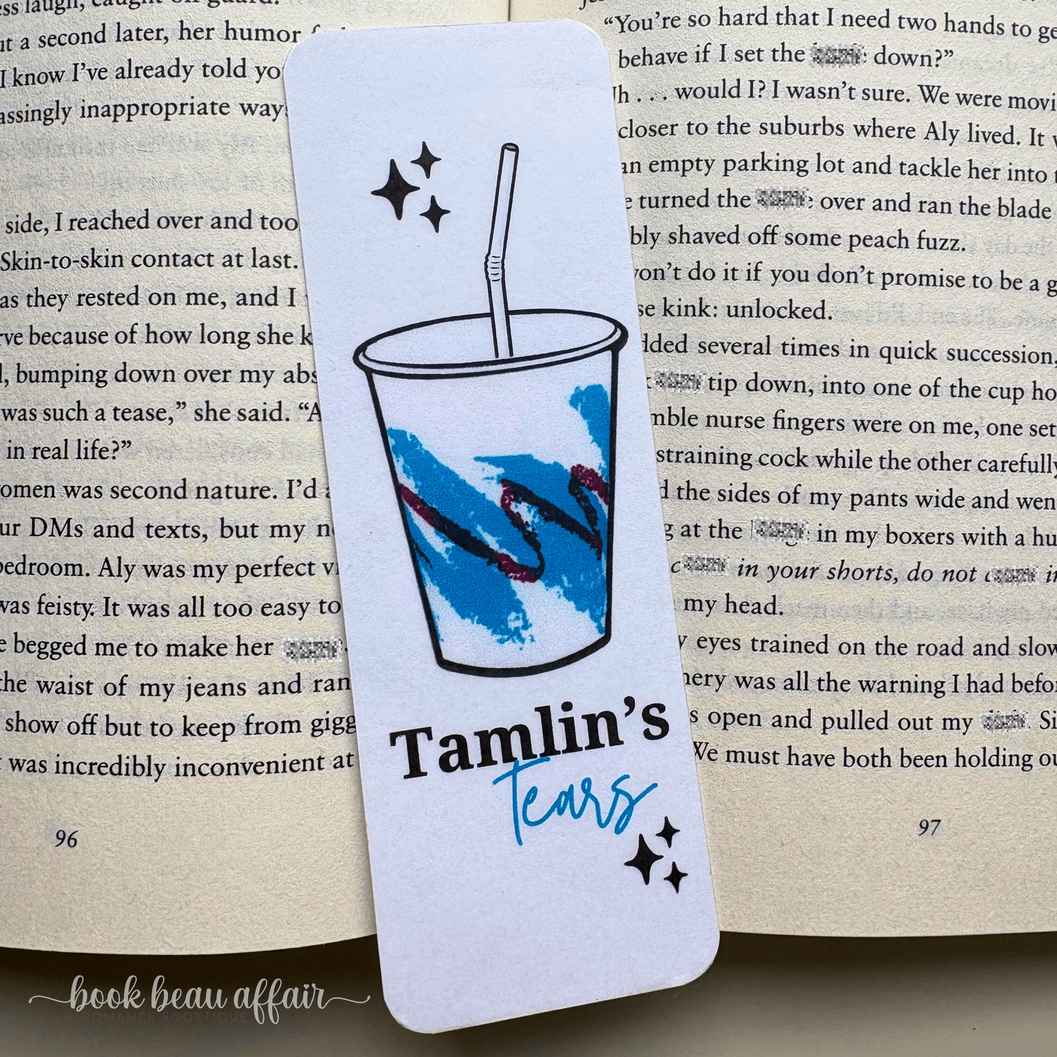 Bookmark with a cup design and 'Tamlin's Tears' text on a book page.