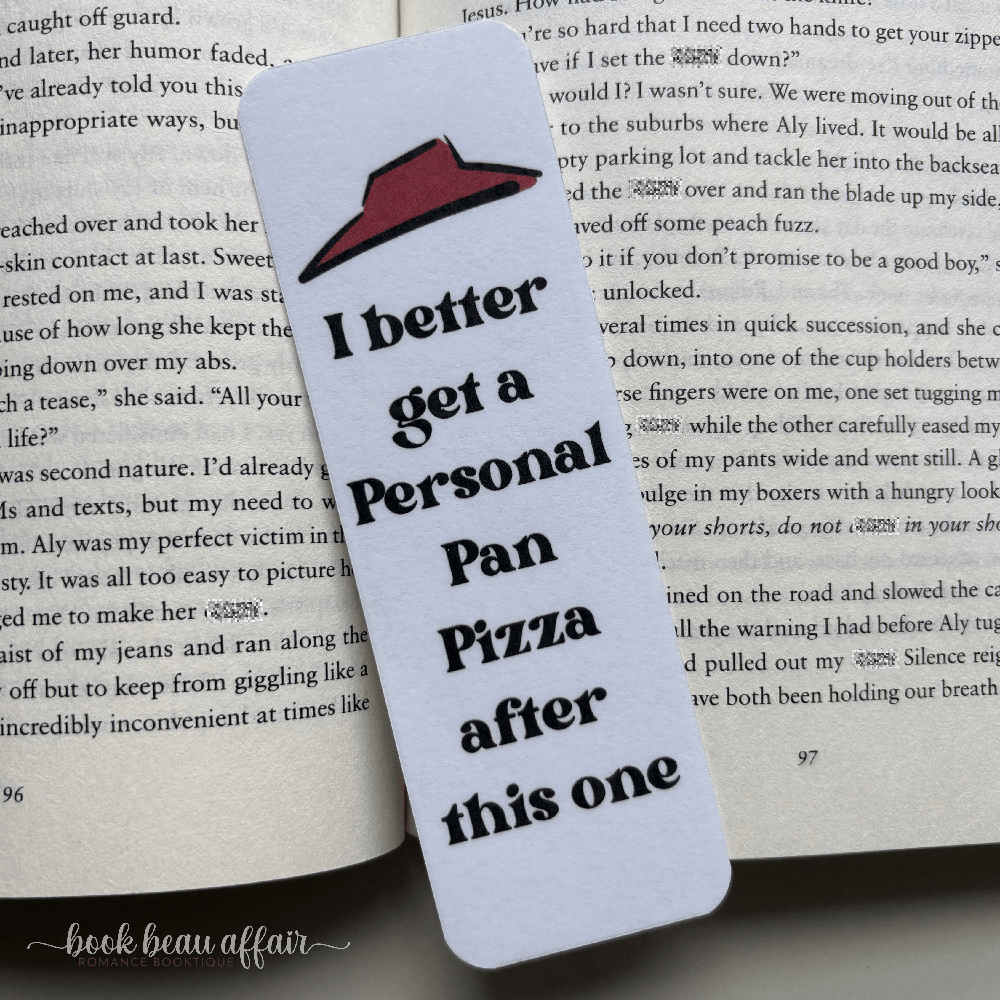 Bookmark with a humorous quote on a book page. quote says I better get a personal pan pizza after this one. Referencing the 90's book it program