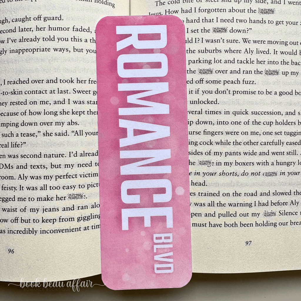 Pink bookmark with 'ROMANCE BLVD' text on a book