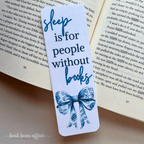 Bookmark with 'sleep is for people without books' text on an open book