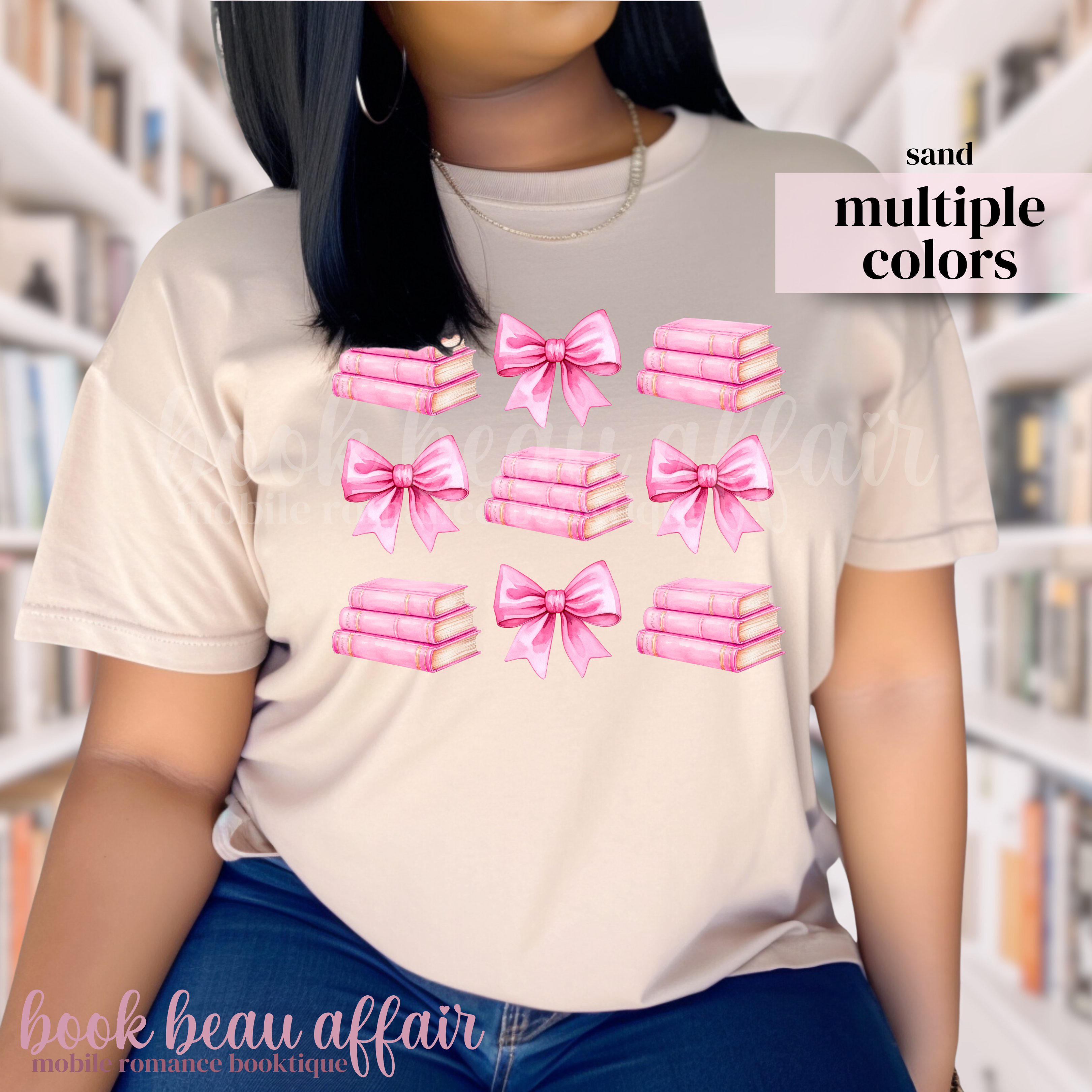 person wearing a beige t-shirt with pink bows and pink stacks of books.
