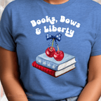 Blue t-shirt with 'Books, Bows & Liberty' design featuring books, cherries, and a bow.