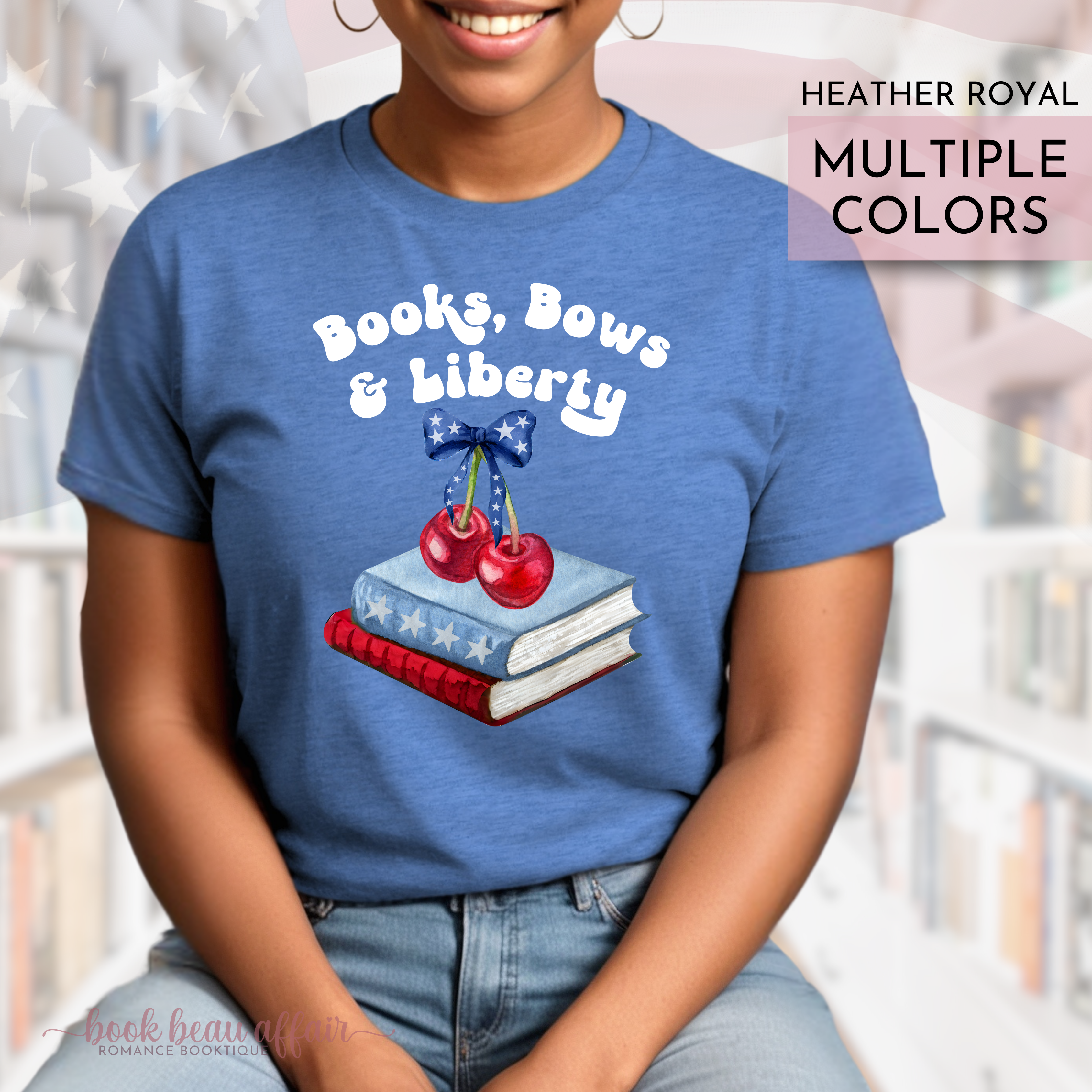 Person wearing a blue t-shirt with 'Books, Bows & Liberty' design in a library setting.