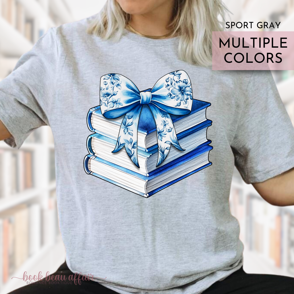 watercolor stack of books and chinoiserie floral bow on top. coquette-style bow. soft bookish tee. Sport Gray