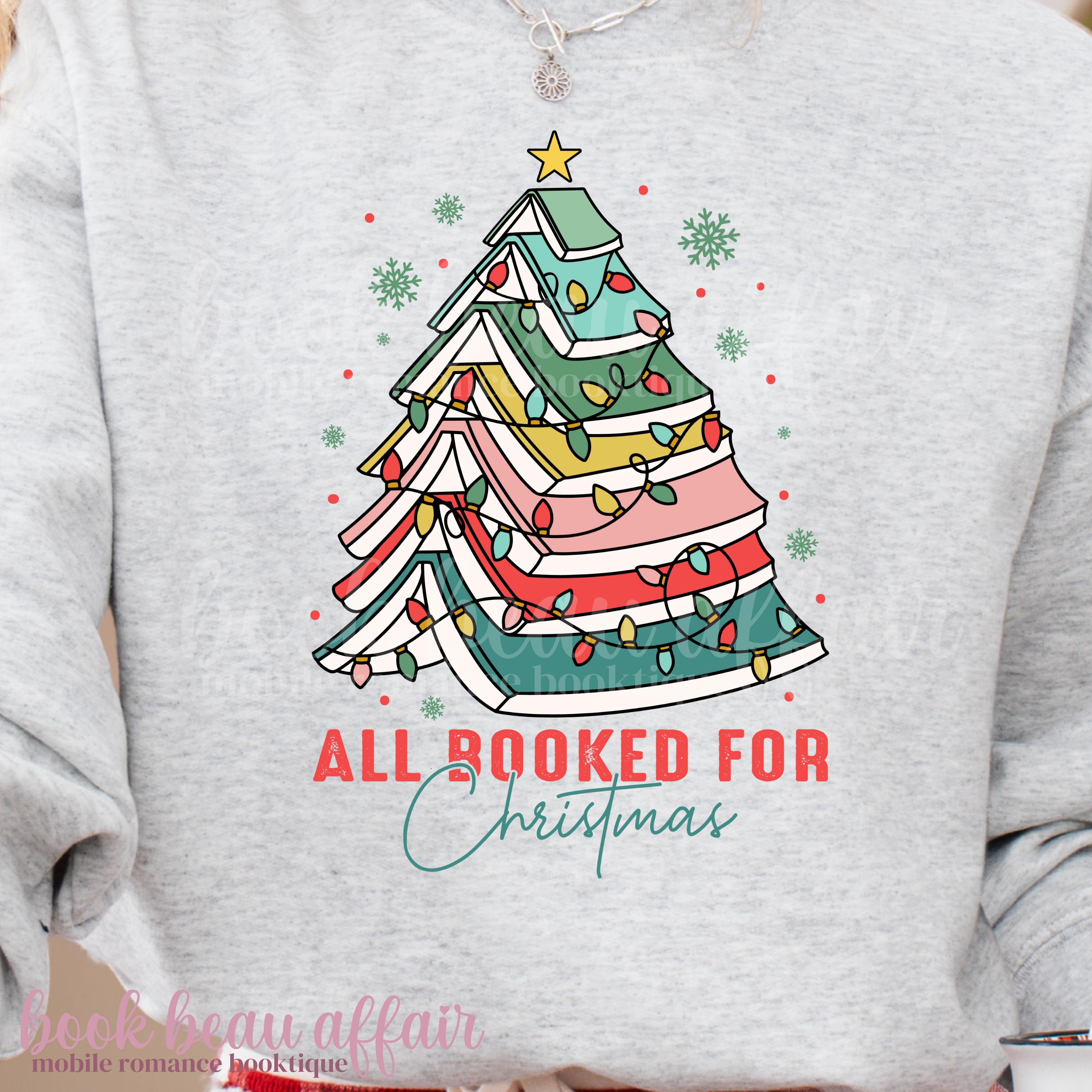 light ash gray sweatshirt with text All Booked For Christmas with a Christmas Tree Made out of books