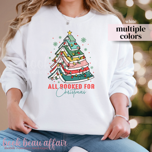 white sweatshirt with text All Booked For Christmas with a Christmas Tree Made out of books