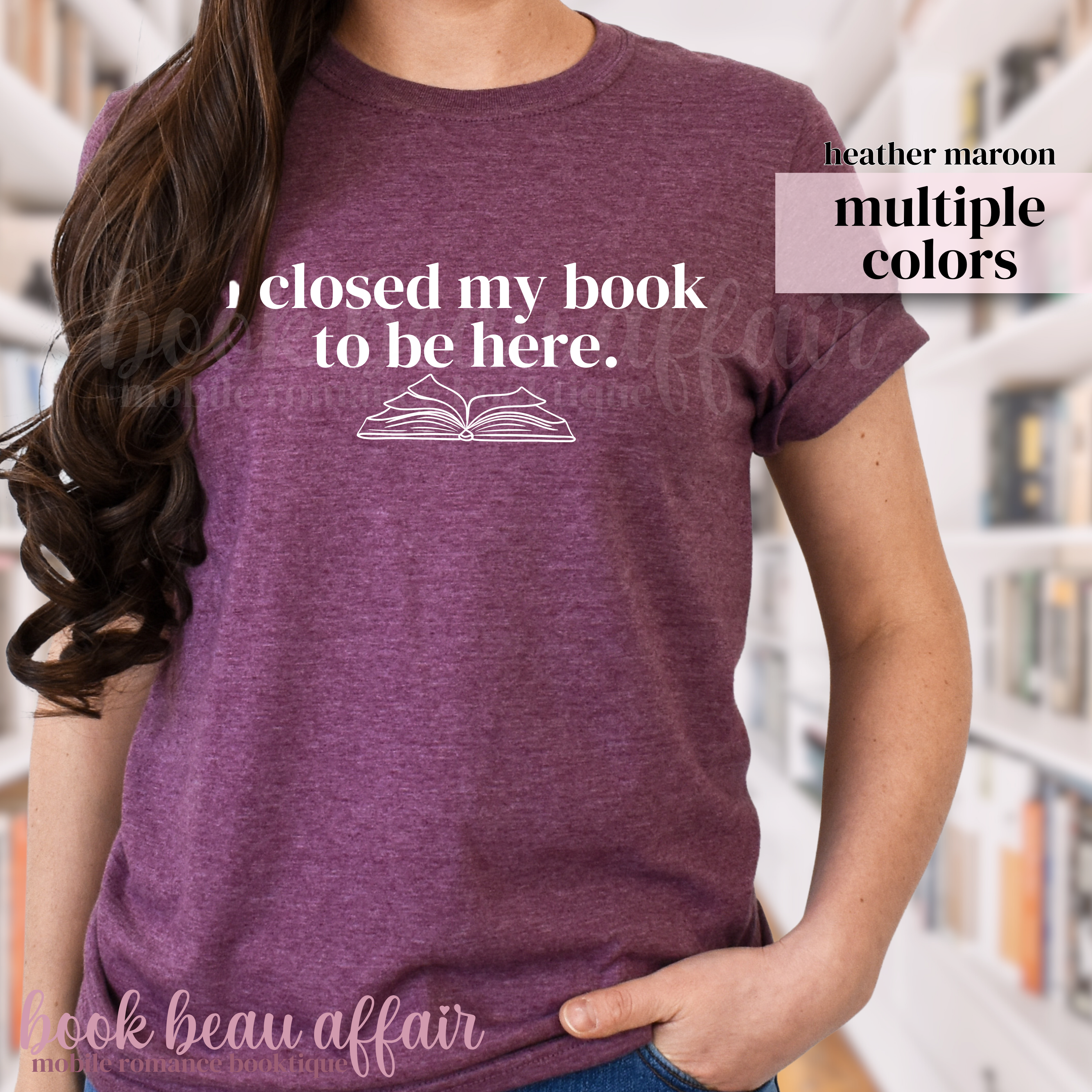 Person wearing a maroon t-shirt with text that says I closed my book to be here