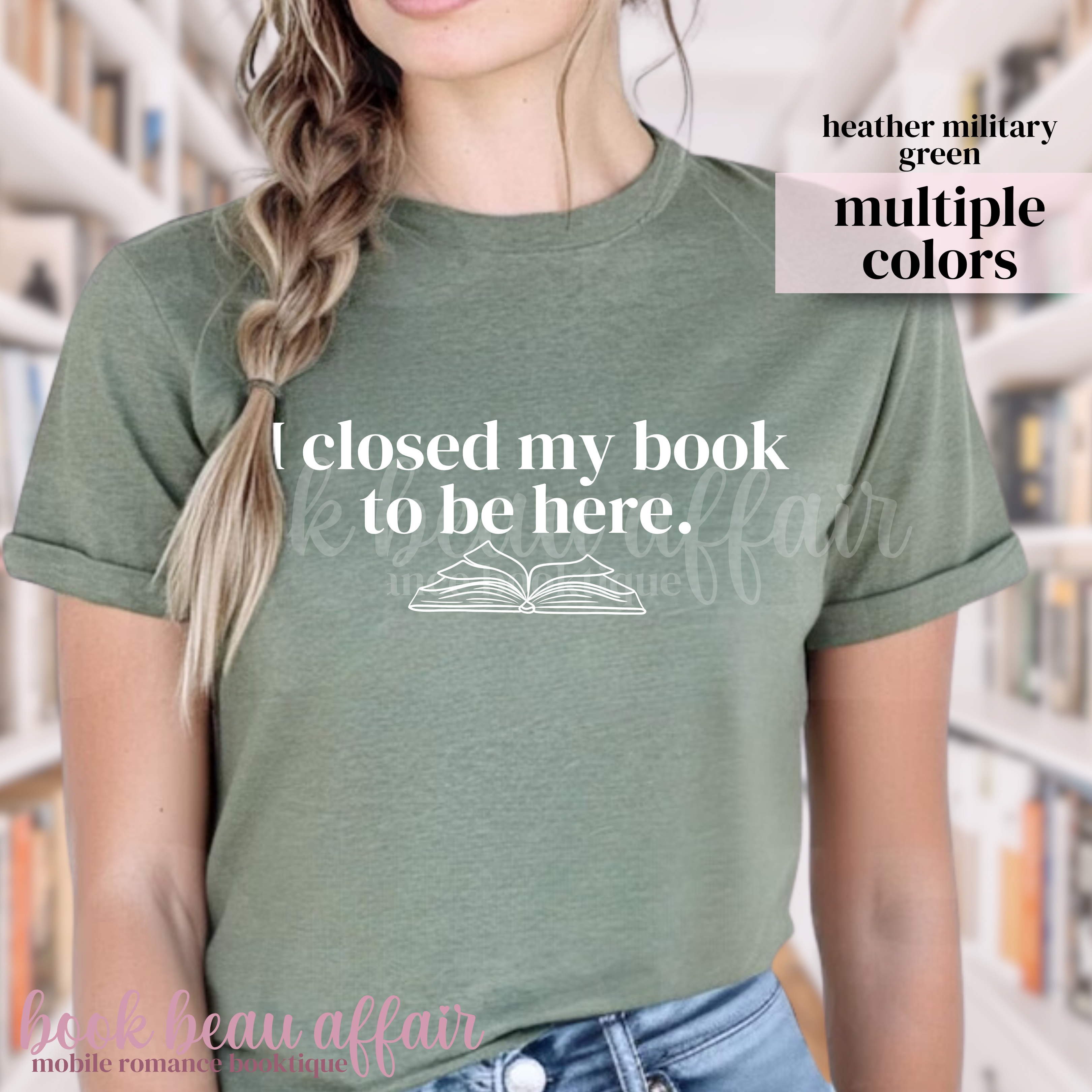 Person wearing a heather military green t-shirt and text that says I closed my book to be here