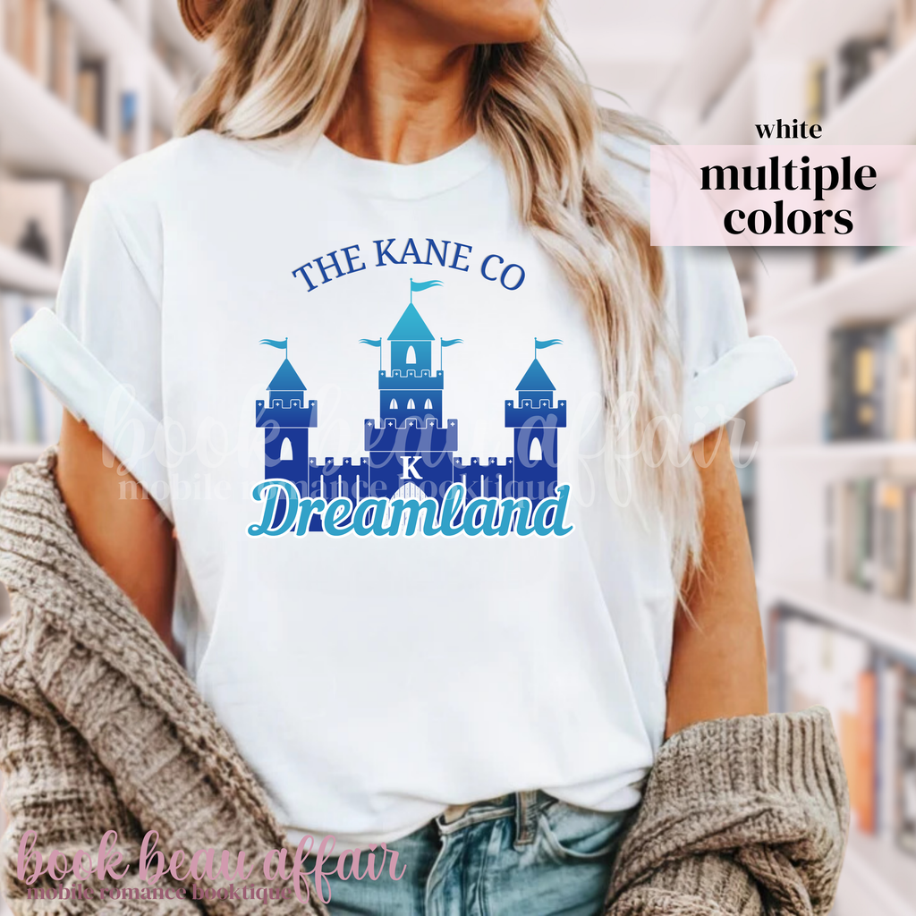 White t-shirt with a blue castle and text that says "The Kane Co Dreamland"