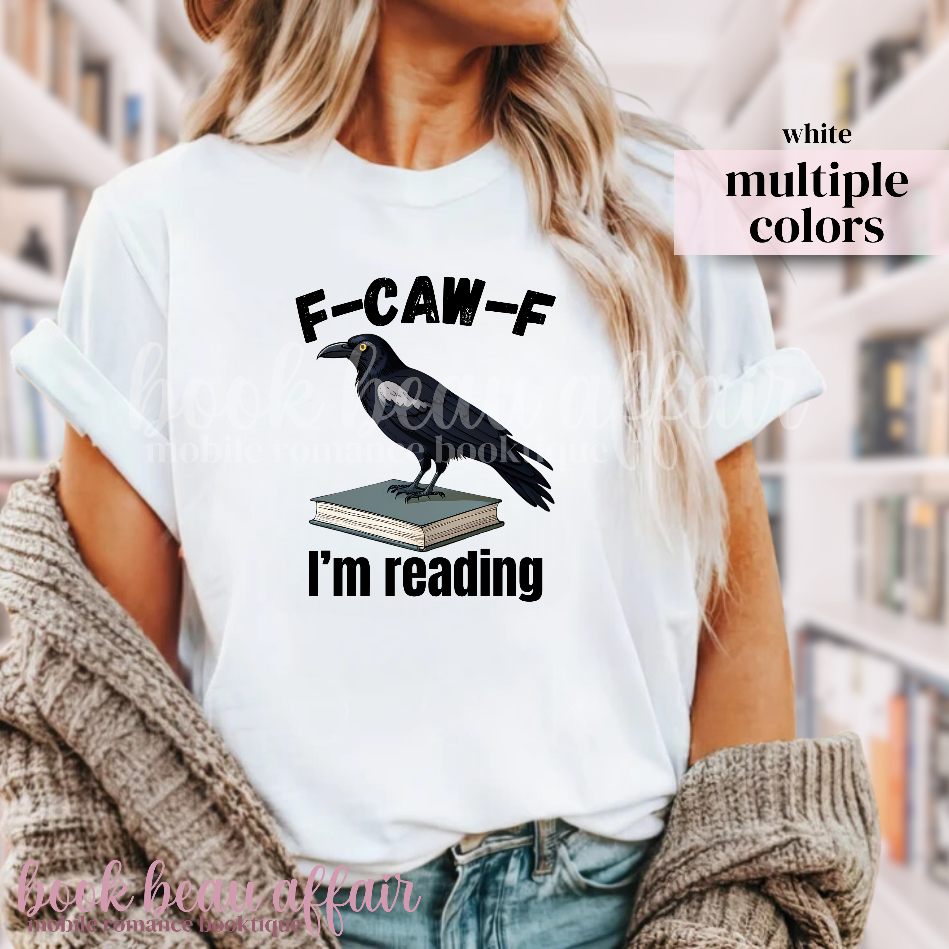 White t-shirt with a crow on a book graphic and text 'F-CAW-F I'm reading' 