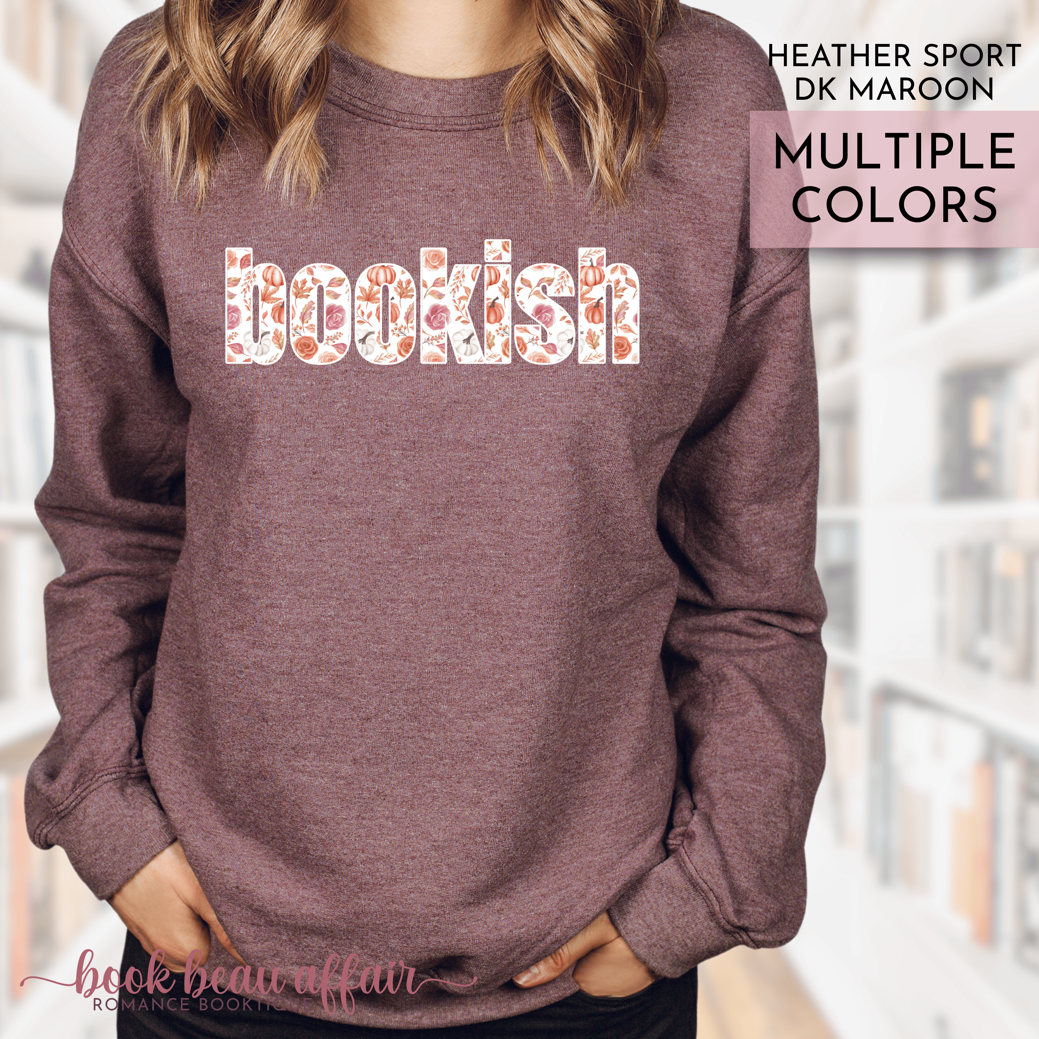 Heather dark maroon sweatshirt with 'bookish' text in multiple colors, worn by a person.