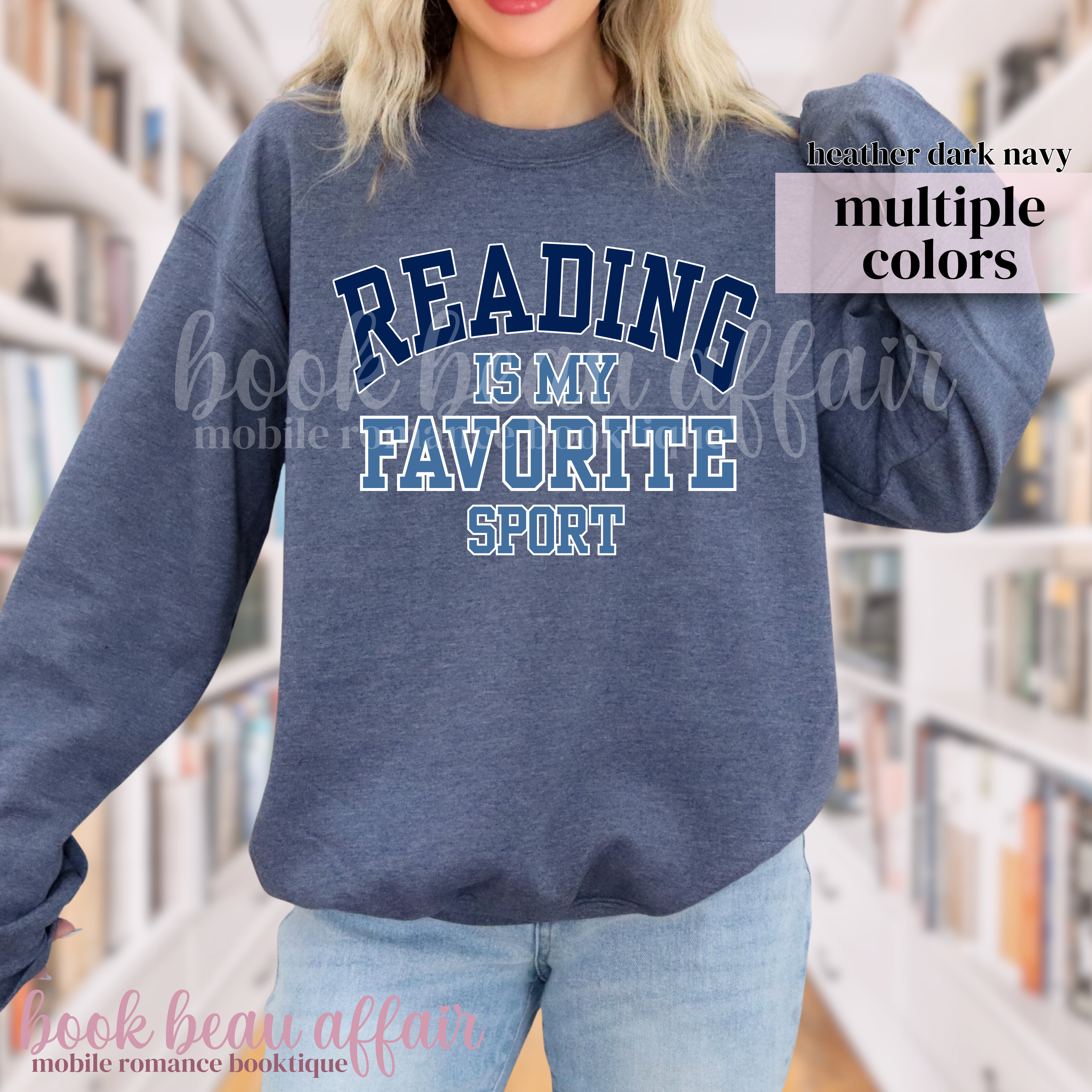 Person wearing a navy sweatshirt with 'Reading is my favorite sport' text in a library setting.