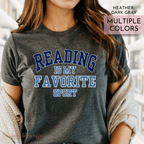 Person wearing a gray t-shirt with 'Reading is my favorite sport' text.