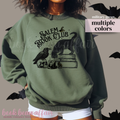 Green sweatshirt with 'Salem Book Club' design and bats in the background