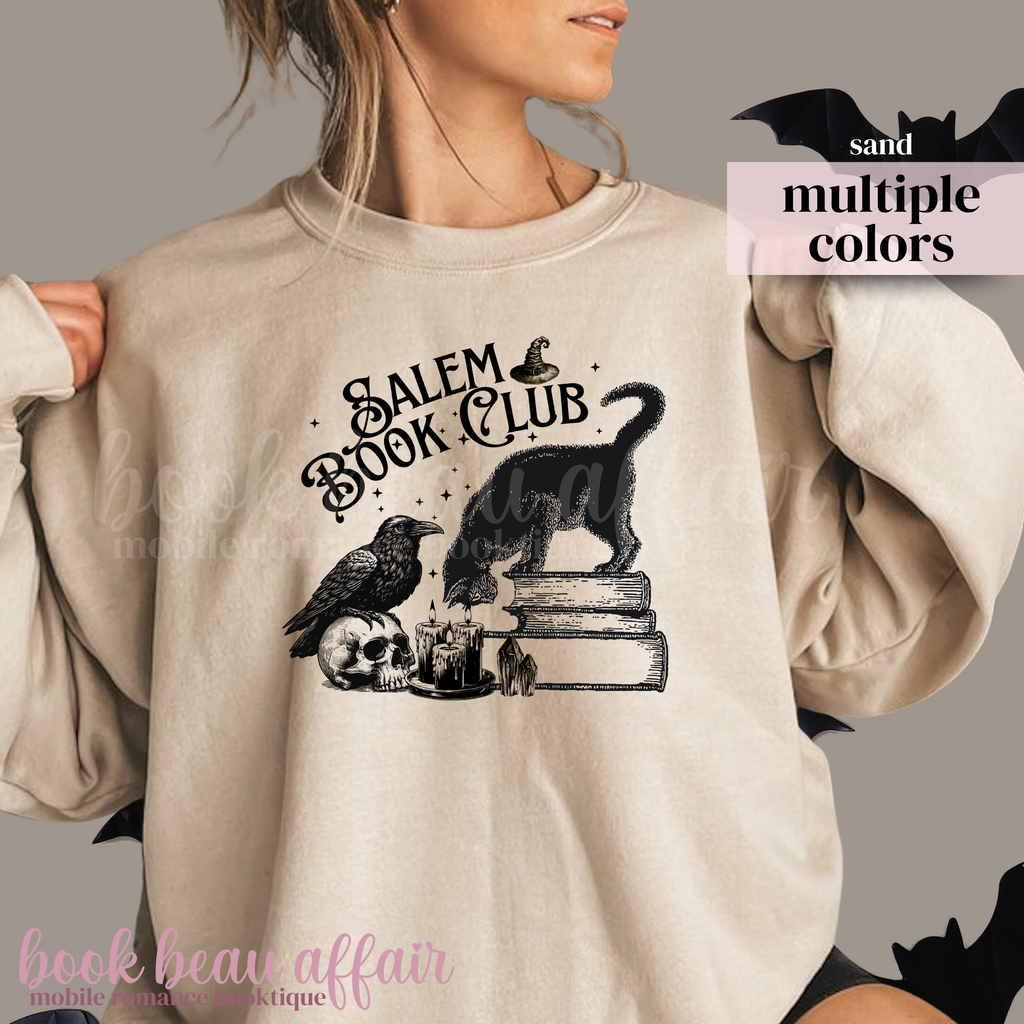 Beige sweatshirt with 'Salem Book Club' design featuring a cat, books, and a raven.