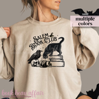 Beige sweatshirt with 'Salem Book Club' design featuring a cat, books, and a raven.
