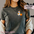 Person wearing a dark gray t-shirt with a ghost and pumpkin graphic, text that says 'read more booooks'