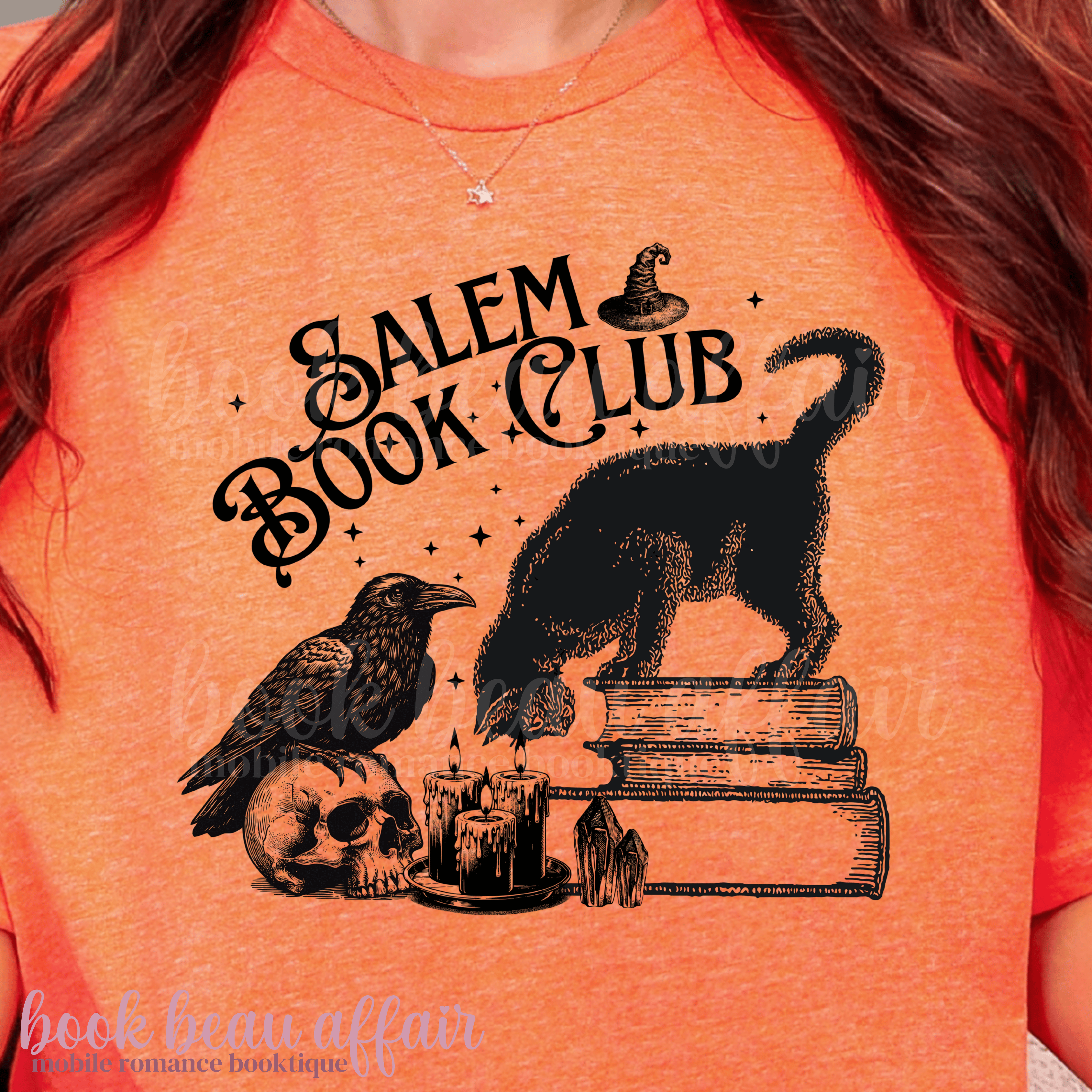 Orange t-shirt with 'Salem Book Club' design featuring a black cat, raven, and books.