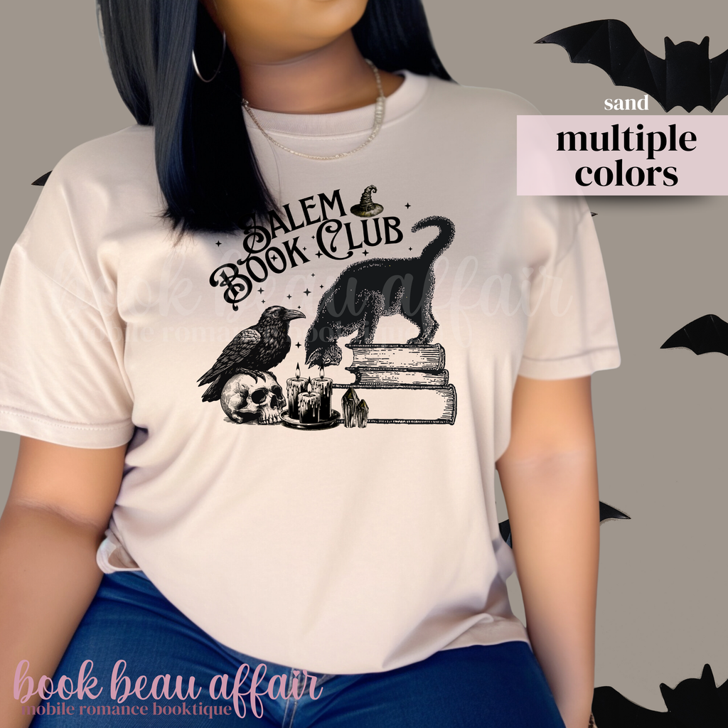 Beige t-shirt with 'Salem Book Club' design featuring a black cat, raven, and books.