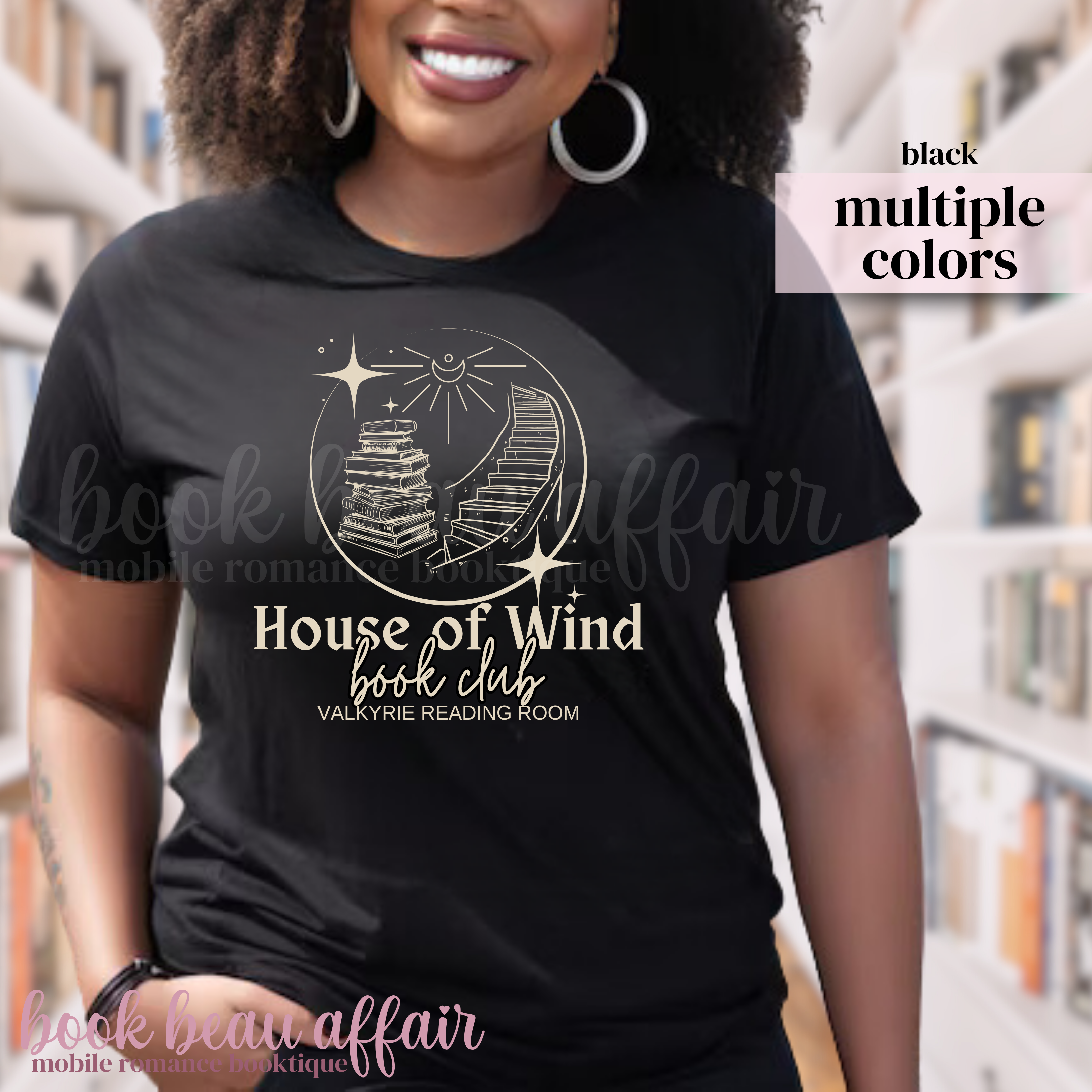Person wearing a black t-shirt with 'House of Wind book club' design in a library setting