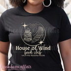 t-shirt with 'House of Wind book club' design in a library setting