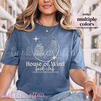 t-shirt with 'House of Wind book club' design in a library setting